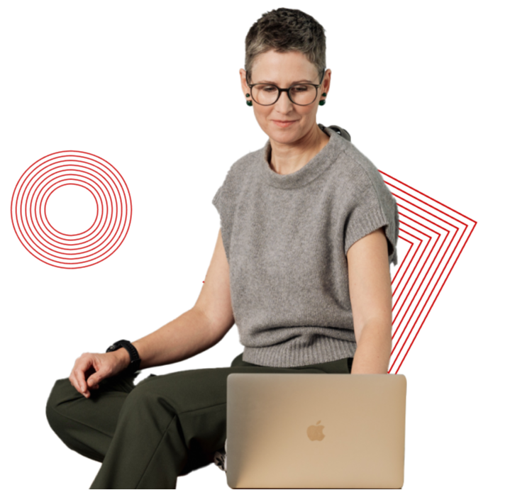 A person with short hair and glasses sits with a laptop, against a geometric red and white background.