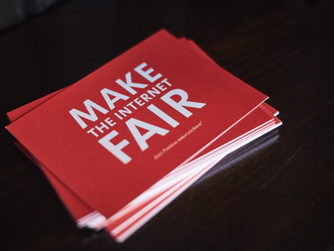 A stack of red cards on a dark surface with white text reading